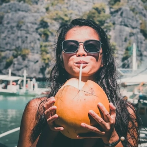 filipina-woman-drinking-buko-in-palawan